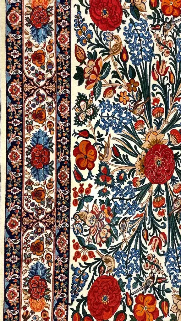 Wool and silk Persian rug featuring intricate floral designs and traditional craftsmanship.